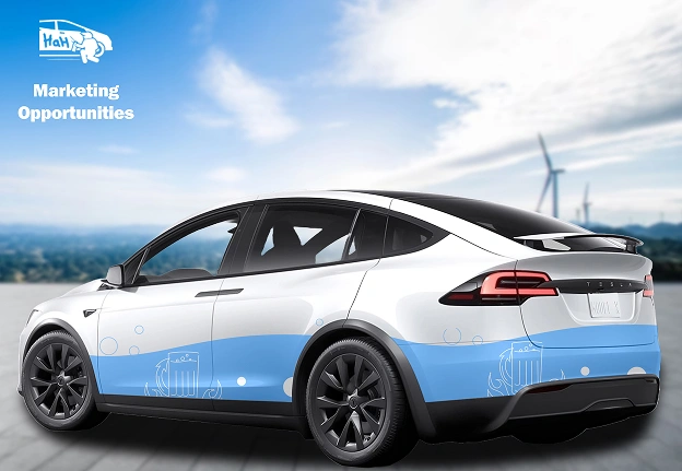 A white Tesla Model X with a blue and white custom vehicle wrap featuring graphics and branding elements. The text "Marketing Opportunities" appears in the top left corner alongside a logo of a van with "HAH" written on it. The car is parked on an open road with wind turbines visible in the background under a bright sky.