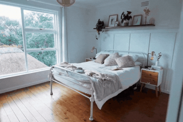 A cozy, sunlit bedroom with large windows treated with window film to reduce heat and UV rays, demonstrating home window tinting benefits like energy savings, thermal comfort, and interior protection.