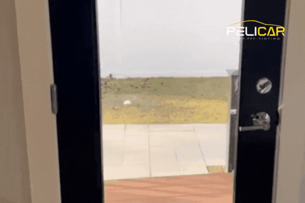 A door with freshly applied window film demonstrates enhanced privacy and UV protection, showcasing home window tinting benefits provided by Pelicar's expert team in Malden, Massachusetts.